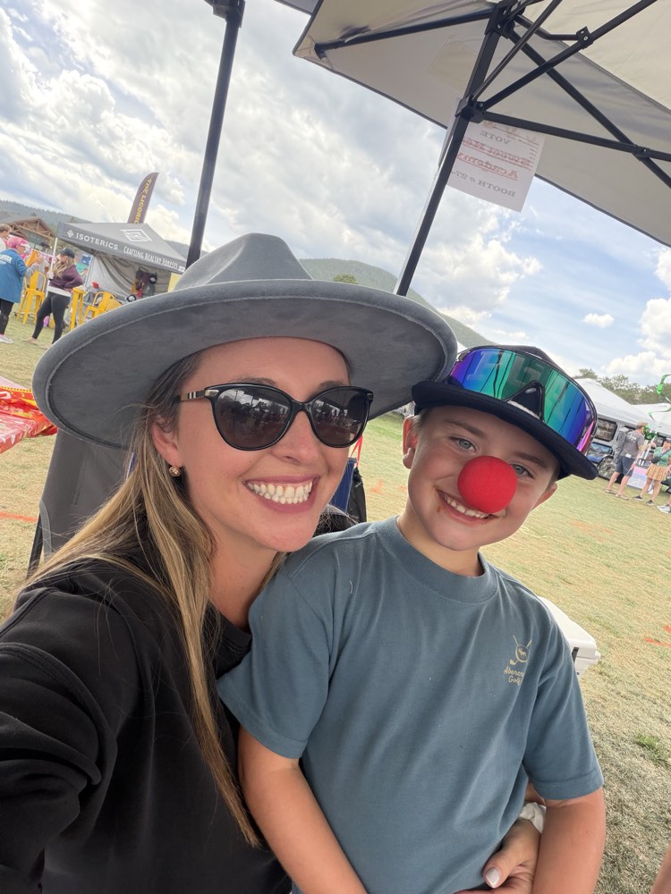 Head of School Lauren Anderson taking a selfie with her son, who is wearing a red clown nose