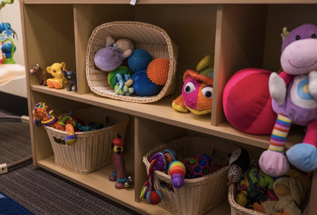 Shelves of colorful toys and baskets in a classroom